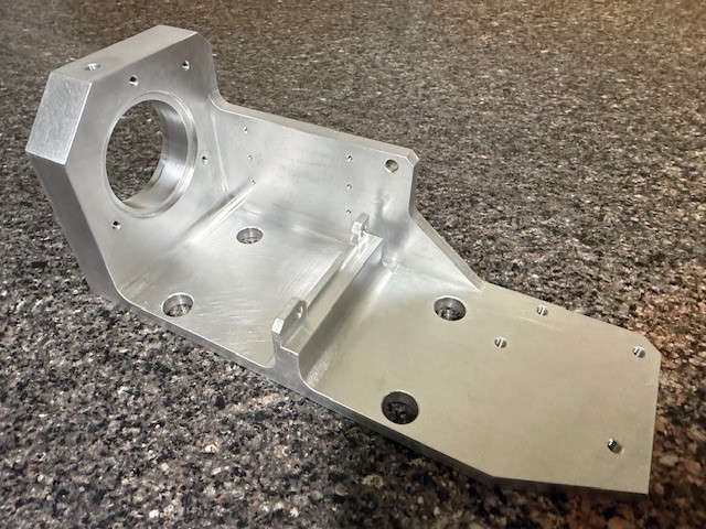 CNC-machined aluminum structural bracket with precision bore and mounting holes