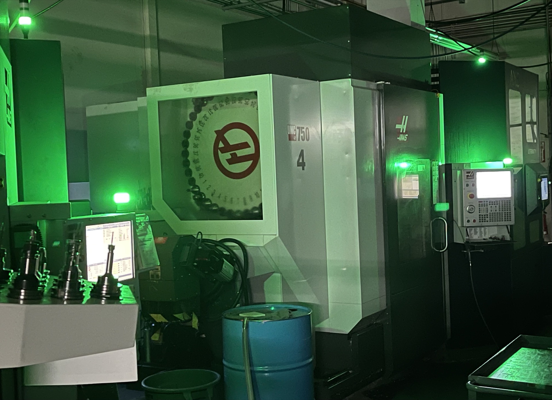 CK Tool machine shop floor — Haas 5-axis CNC machining centers running overnight with green status lights