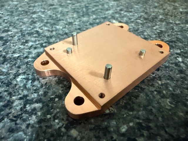 Precision-machined copper mounting plate with press-fit pins