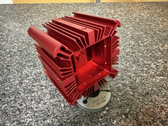 Red-anodized CNC-machined aluminum heatsink housing with precision fin detail